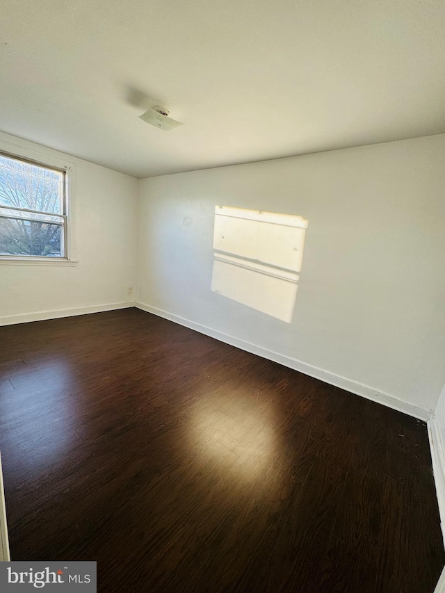 empty room with dark hardwood / wood-style floors