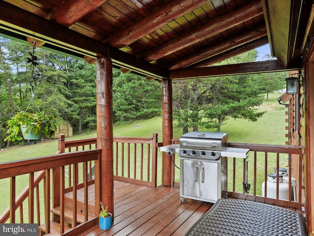 wooden deck featuring a yard and grilling area