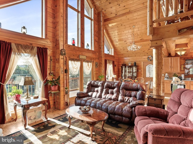 living room with high vaulted ceiling, a chandelier, light hardwood / wood-style floors, wooden walls, and wood ceiling