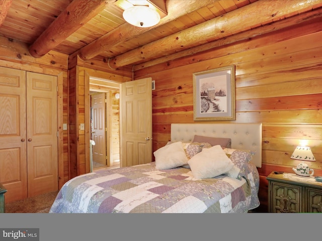 bedroom featuring wood walls, beam ceiling, wood ceiling, and a closet