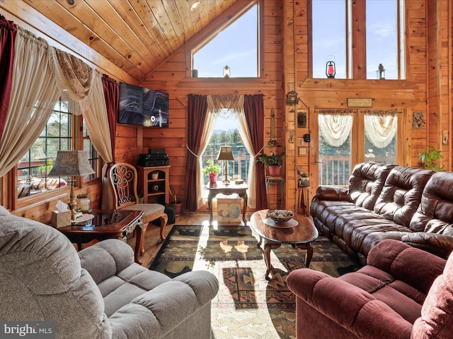 living room with wood walls, high vaulted ceiling, and wooden ceiling