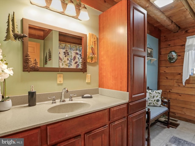 bathroom with tile patterned flooring, vanity, wooden ceiling, and wooden walls