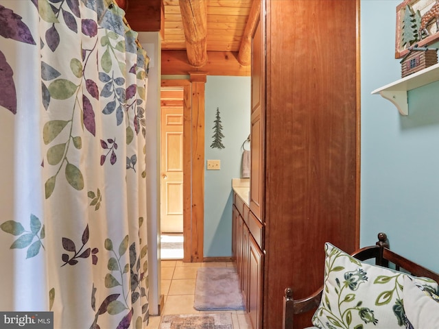 bathroom featuring tile patterned flooring and wooden ceiling