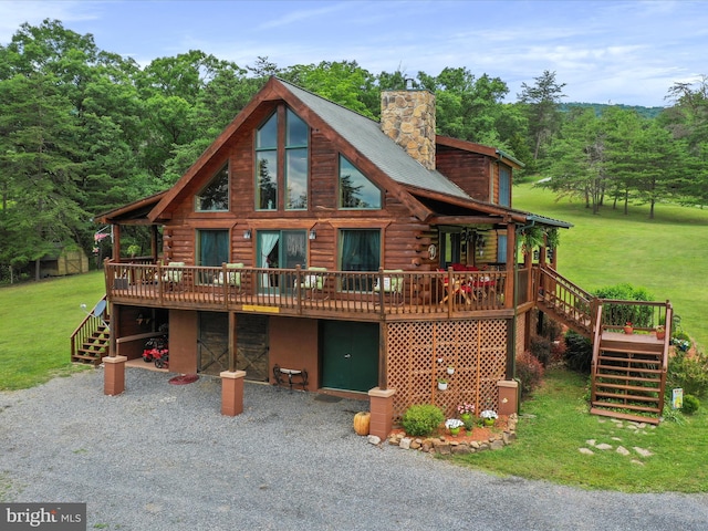 log home featuring a wooden deck and a front yard