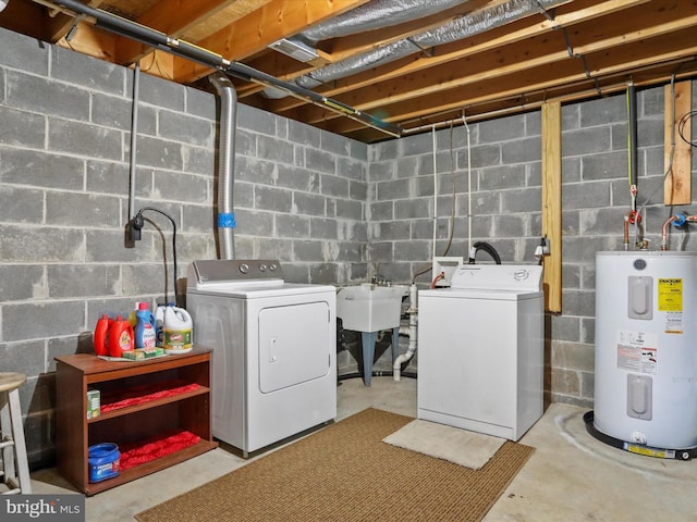 clothes washing area featuring independent washer and dryer, sink, and water heater