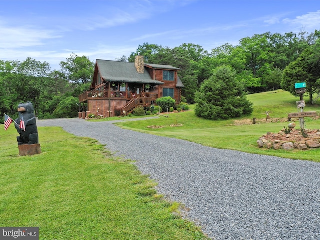 log cabin featuring a front yard and a wooden deck