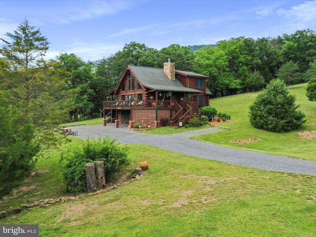 log-style house with a deck and a front lawn