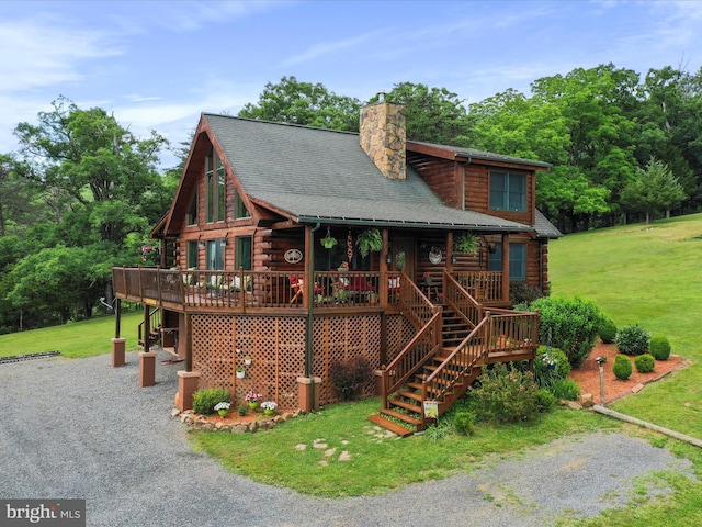 log-style house with a deck and a front yard