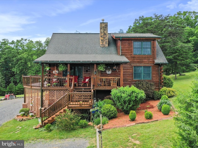 back of house with a yard and a deck