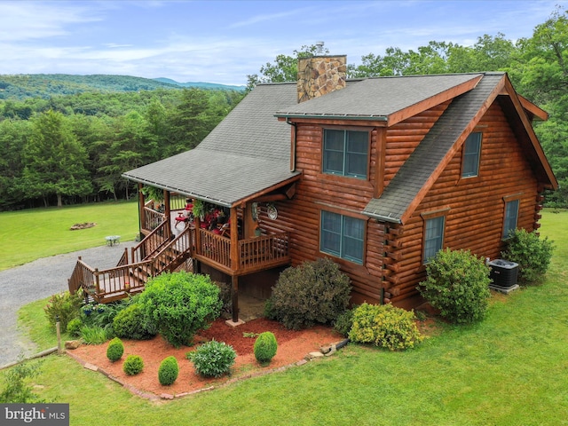 cabin with a porch, cooling unit, and a front yard