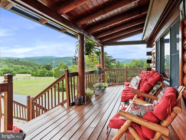 deck with a lawn and a mountain view