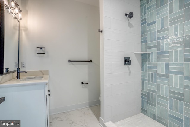 bathroom featuring vanity, toilet, and a tile shower