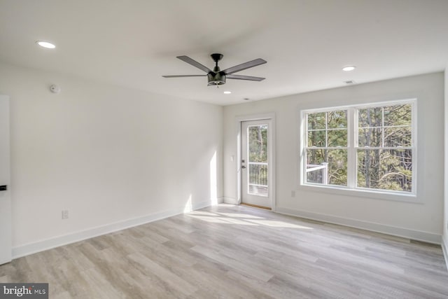 empty room featuring ceiling fan and light wood-type flooring