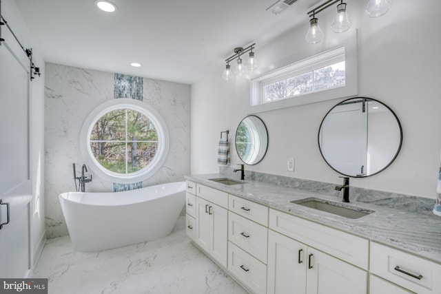 bathroom featuring a tub to relax in and vanity