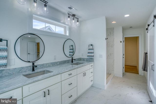 bathroom with a shower and vanity