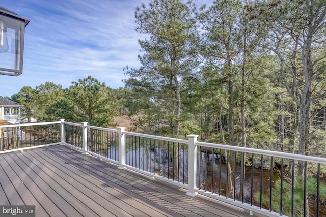 wooden deck featuring a water view