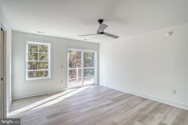 empty room featuring ceiling fan and light hardwood / wood-style floors