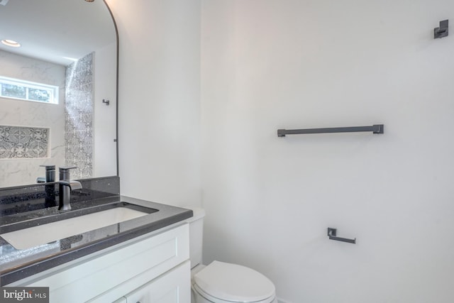 bathroom with toilet and vanity