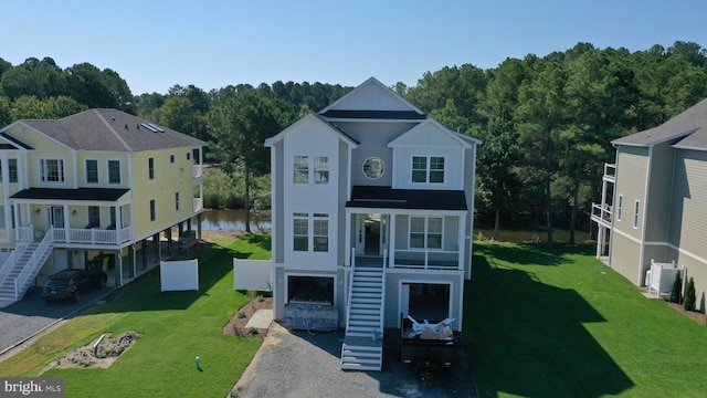 view of outbuilding with a lawn and a water view