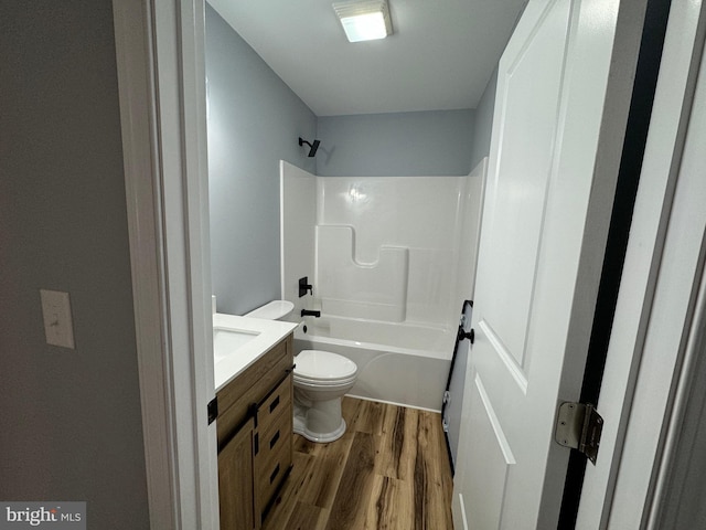 full bathroom featuring hardwood / wood-style flooring, vanity, toilet, and tub / shower combination