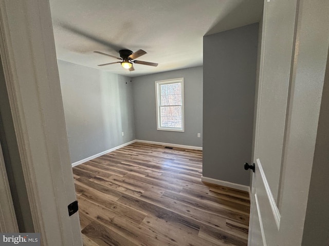 spare room featuring ceiling fan and hardwood / wood-style floors