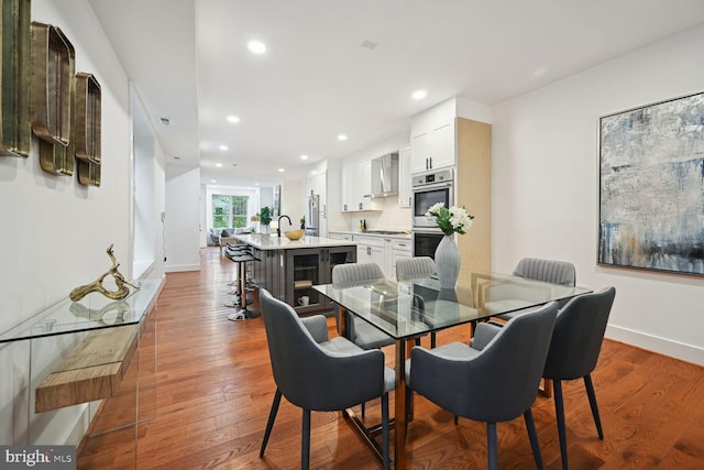 dining area featuring dark hardwood / wood-style flooring and sink