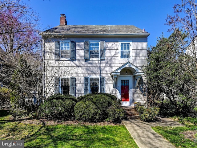 colonial inspired home with a front yard