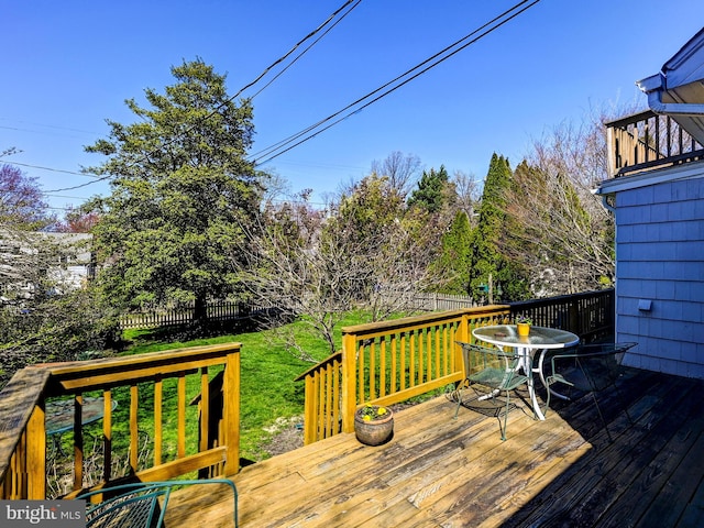 wooden deck with a lawn