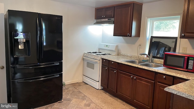 kitchen featuring dark brown cabinetry, black appliances, sink, and light tile flooring