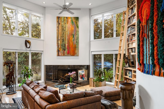 living room with ceiling fan and light wood-type flooring