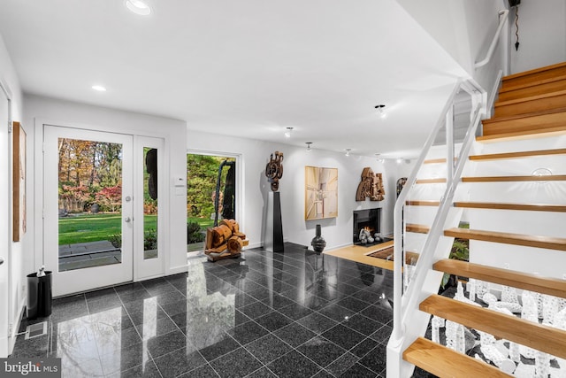 staircase with dark tile floors