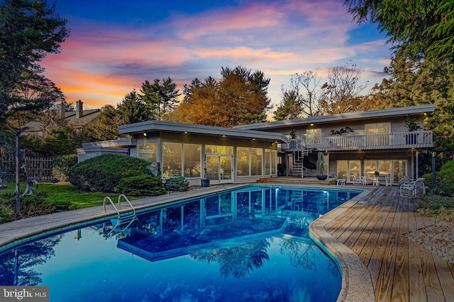 view of pool at dusk