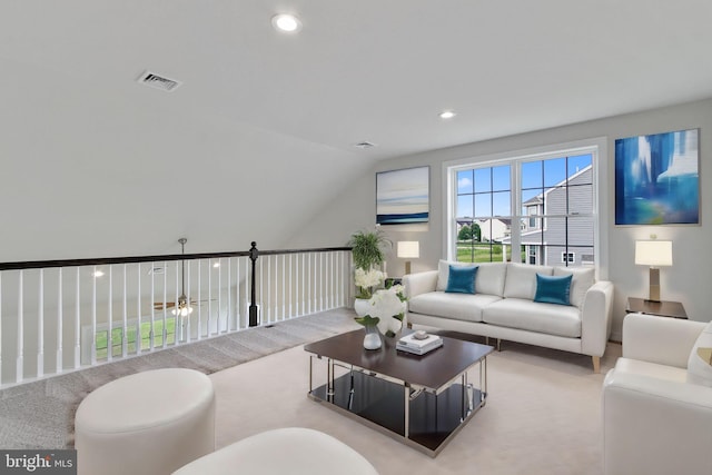 living room with ceiling fan, light colored carpet, and lofted ceiling