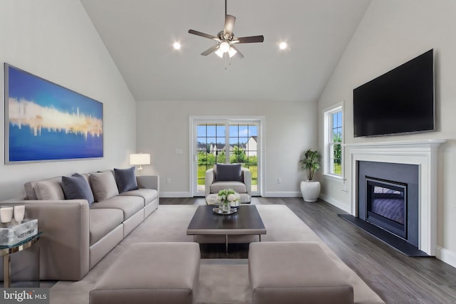 living room with wood-type flooring, high vaulted ceiling, and ceiling fan