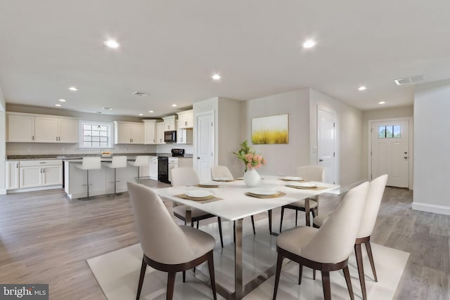 dining room with light wood-type flooring