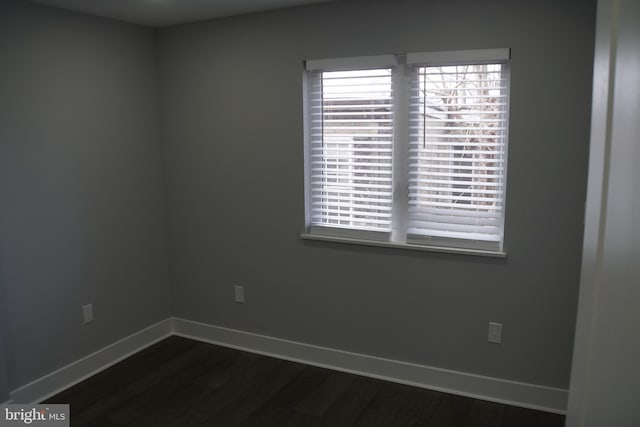 unfurnished room featuring dark hardwood / wood-style flooring