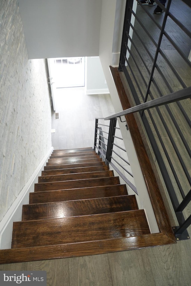 staircase with dark wood-type flooring