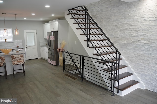 stairs with dark wood-type flooring