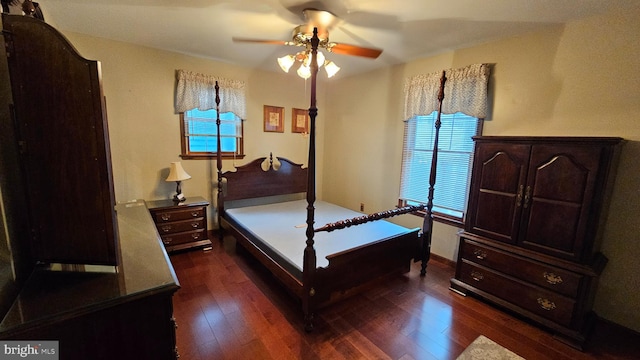 bedroom with ceiling fan and dark hardwood / wood-style floors