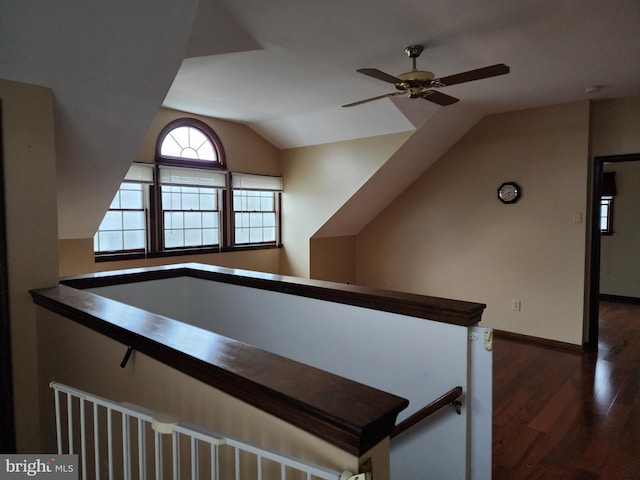 interior space featuring dark hardwood / wood-style floors, ceiling fan, and lofted ceiling