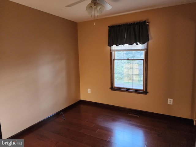 spare room featuring ceiling fan and dark hardwood / wood-style floors