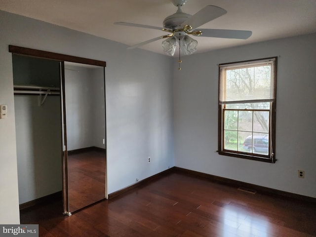 unfurnished bedroom featuring a closet, ceiling fan, and dark hardwood / wood-style floors