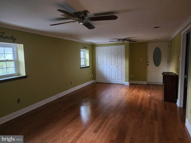 spare room featuring ceiling fan, dark hardwood / wood-style flooring, and ornamental molding