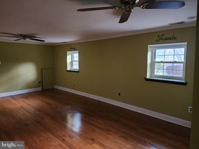 spare room featuring crown molding, dark wood-type flooring, and ceiling fan