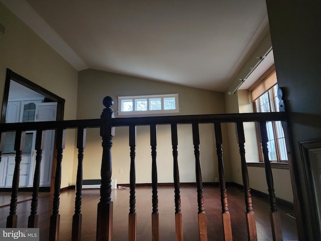 stairway featuring a wealth of natural light, dark tile flooring, and high vaulted ceiling