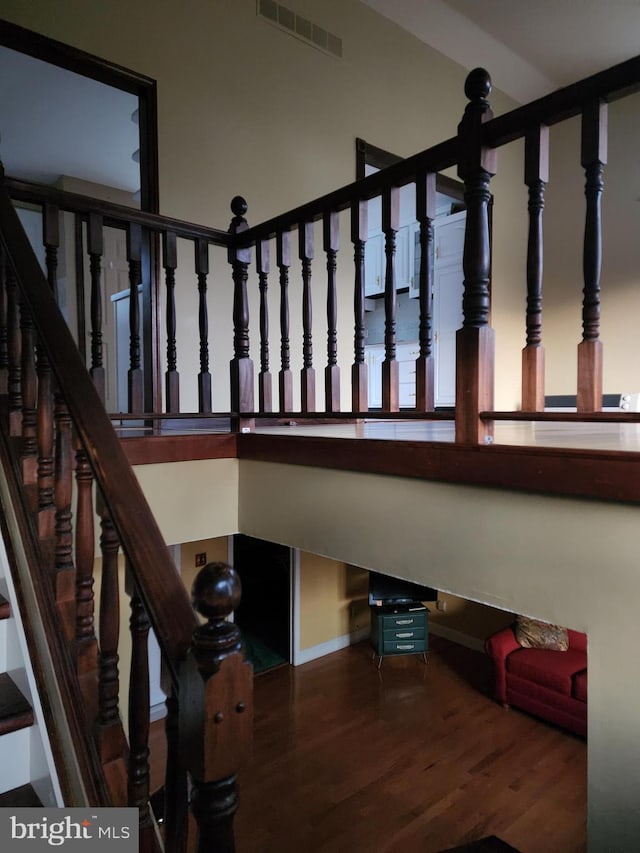 stairway with dark wood-type flooring