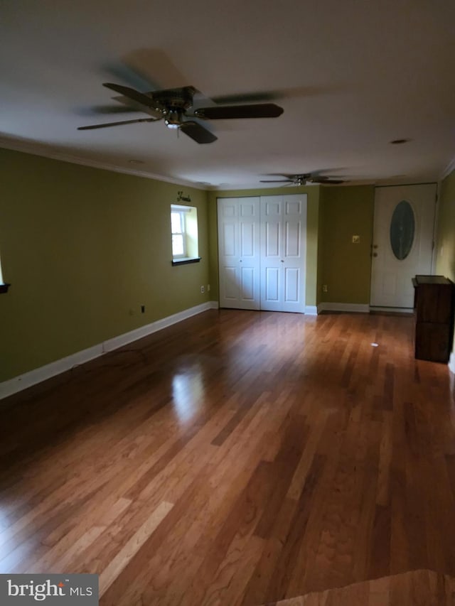 unfurnished room featuring ornamental molding, ceiling fan, and dark hardwood / wood-style floors