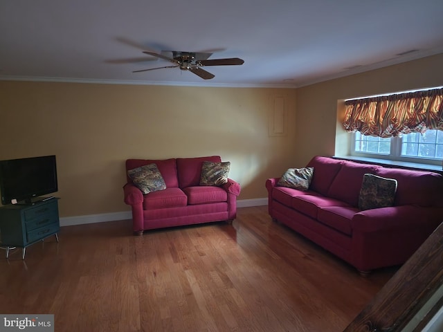 living room featuring ornamental molding, ceiling fan, and dark hardwood / wood-style floors