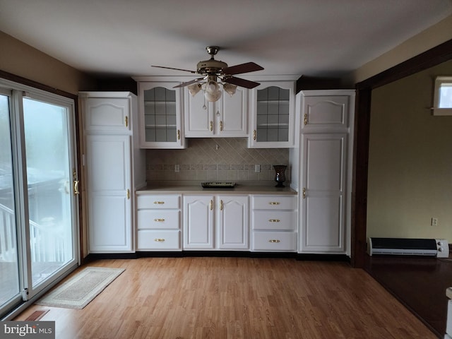 kitchen featuring tasteful backsplash, light hardwood / wood-style flooring, ceiling fan, and white cabinetry