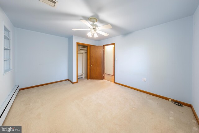 unfurnished bedroom featuring visible vents, carpet floors, a baseboard radiator, baseboards, and a closet